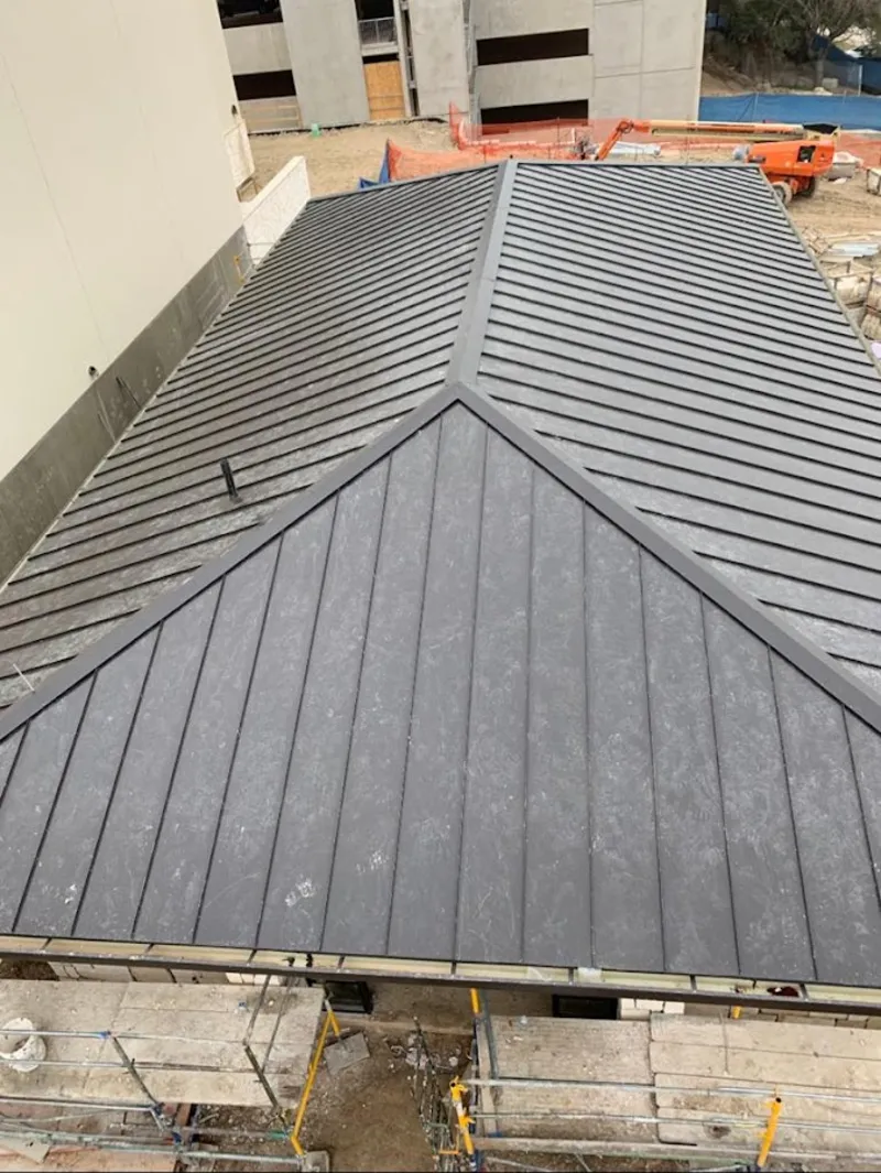 Commercial metal roof construction with crane equipment in Jacinto City