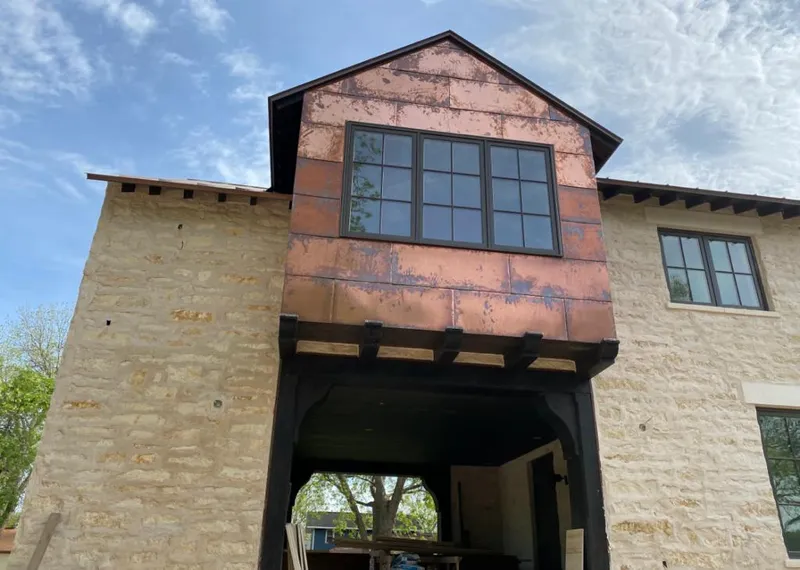 Copper metal panel facade on a stone building for Metal Roof Coating in Jacinto City